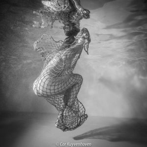 Naakte vrouw onderwater met net